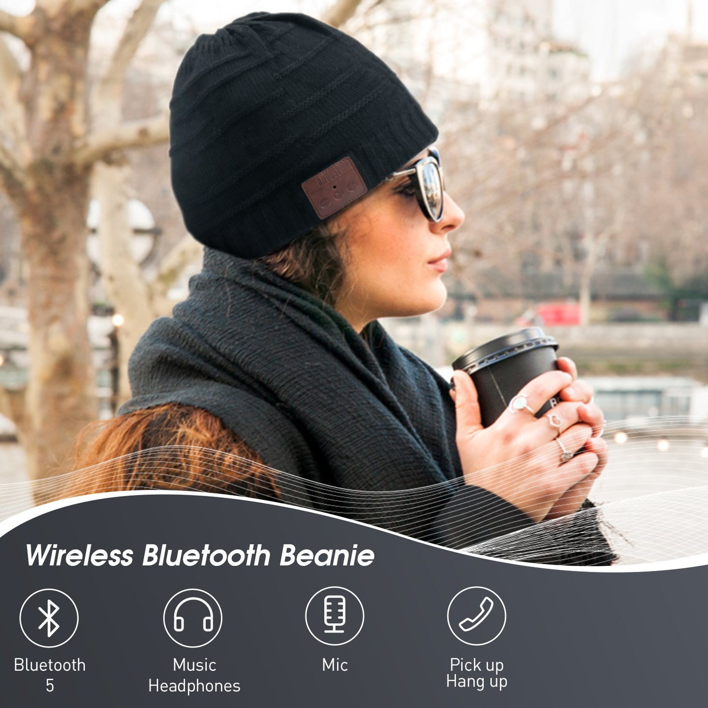 A lady holds a warm takeaway coffee cup and her ears are completely covered by the EPA25 beanie